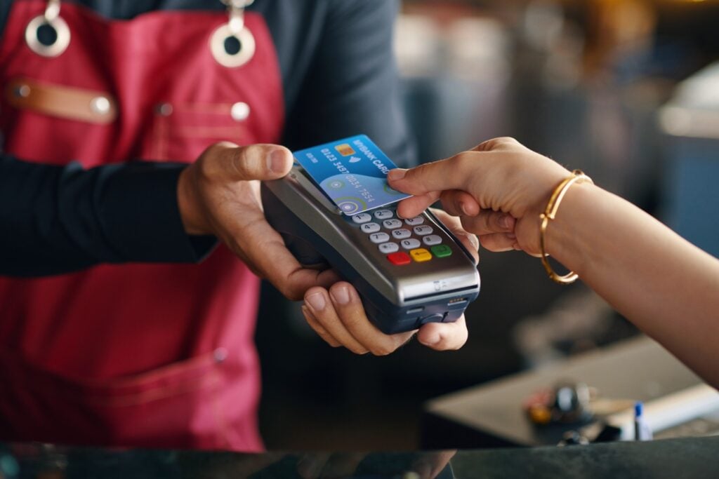 Shopper using a payment card during a sale event associated with Afterpay scam activity