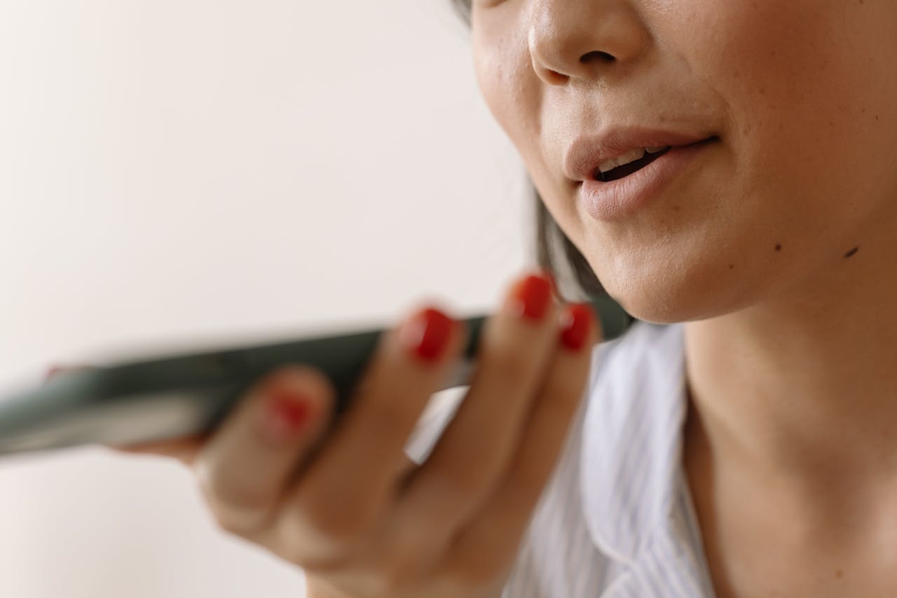 Person listening closely to a phone message that could be an AI voice cloning family emergency scam