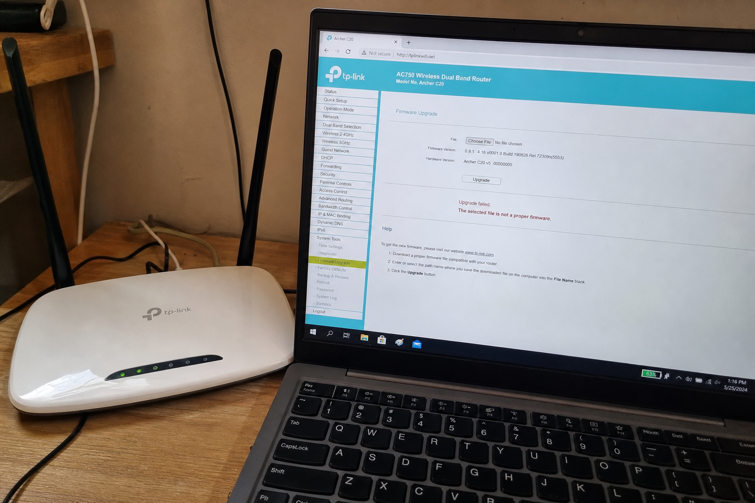 Your Archer C20 can take a command from the admin page. Install 0.9.1 1 TP-Link Archer C20 router on a desk next to a laptop showing the Firmware Upgrade page