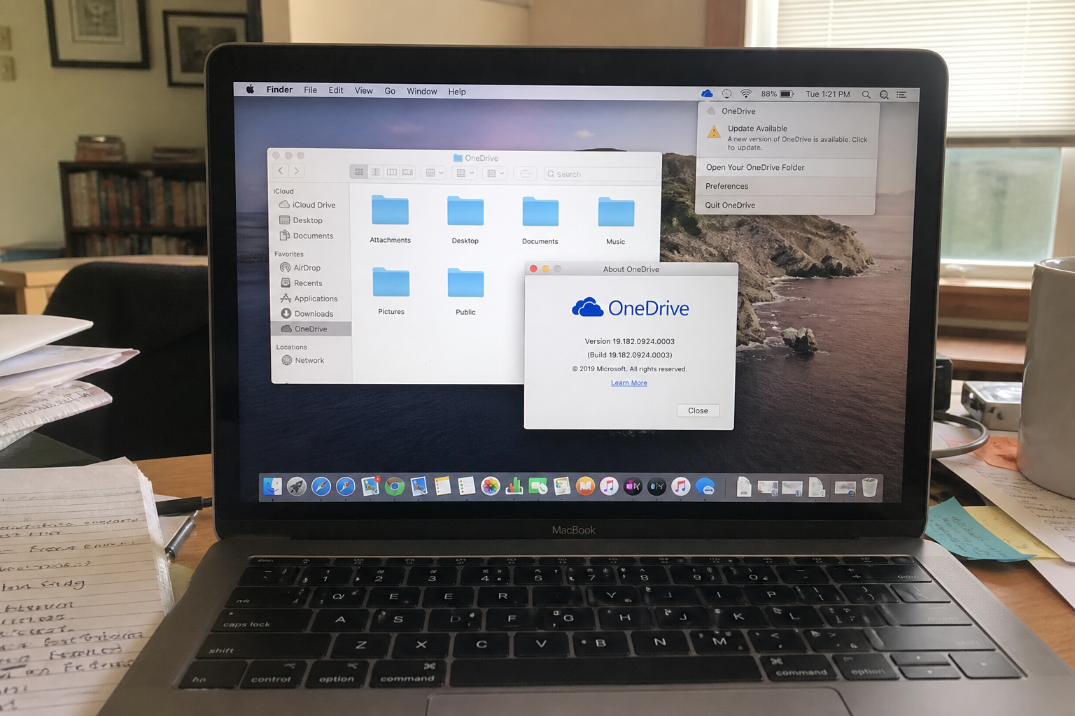 OneDrive on the Mac can raise privileges. Take 26.095.0519.0003 1 MacBook showing OneDrive About box version 19.182 and a menu bar Update Available notice